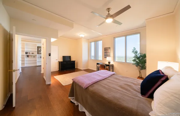 a bedroom with a large bed and a chandelier