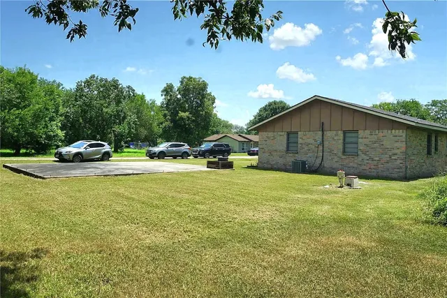 a backyard of a house with table and chairs