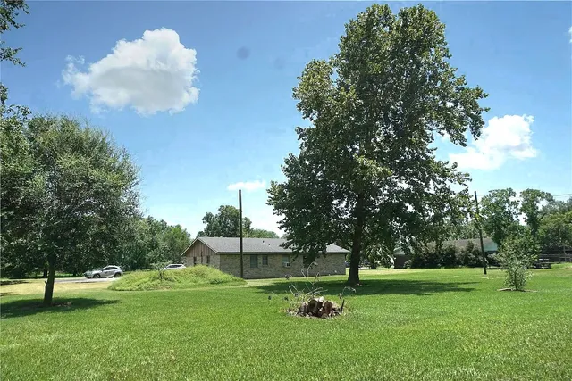 a front view of a house with a yard and trees