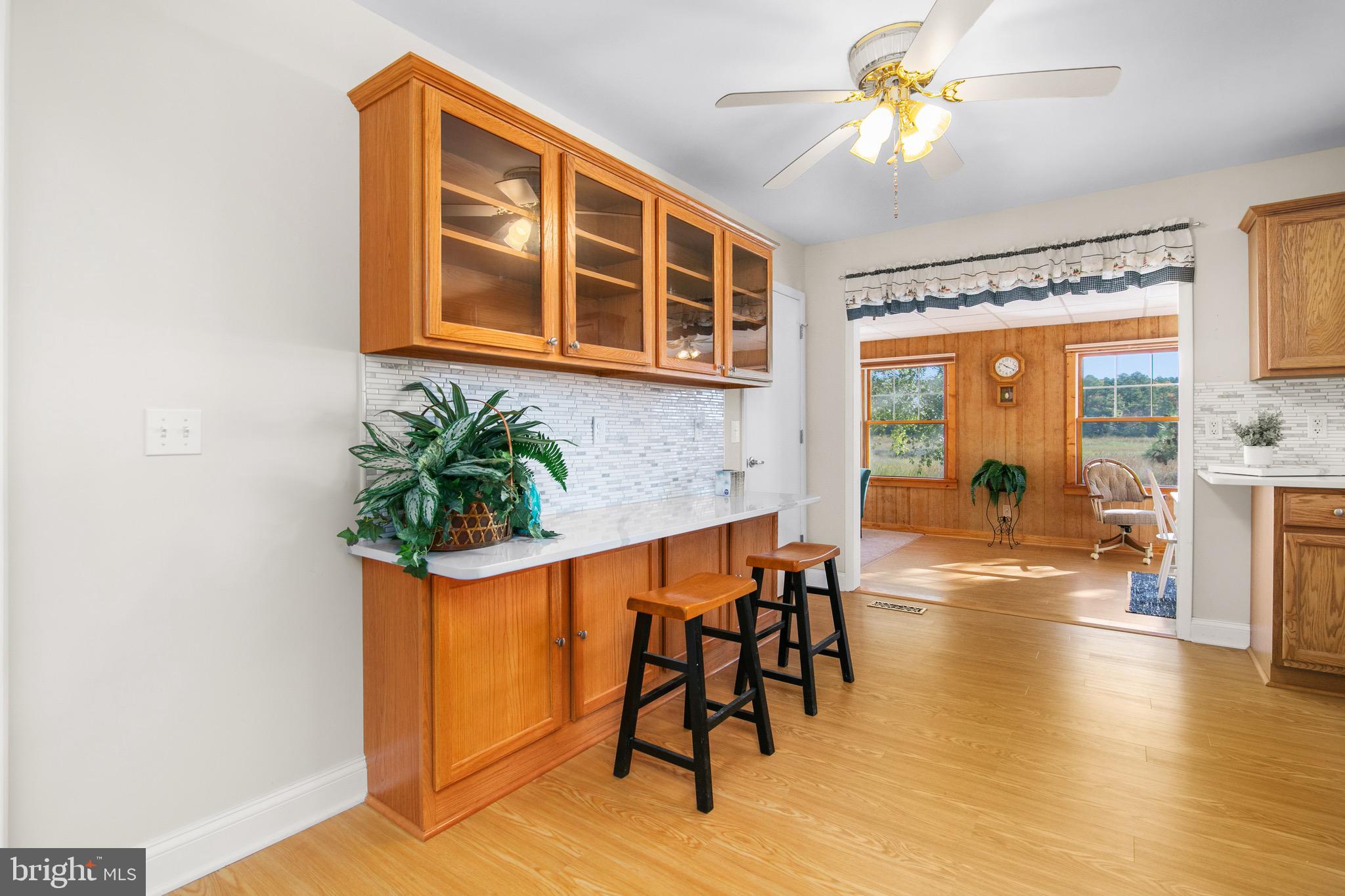 21633 Wetipquin Road Tyaskin, MD 21865 - Photo 16 of 88 a dining room with furniture a potted plant and wooden floor