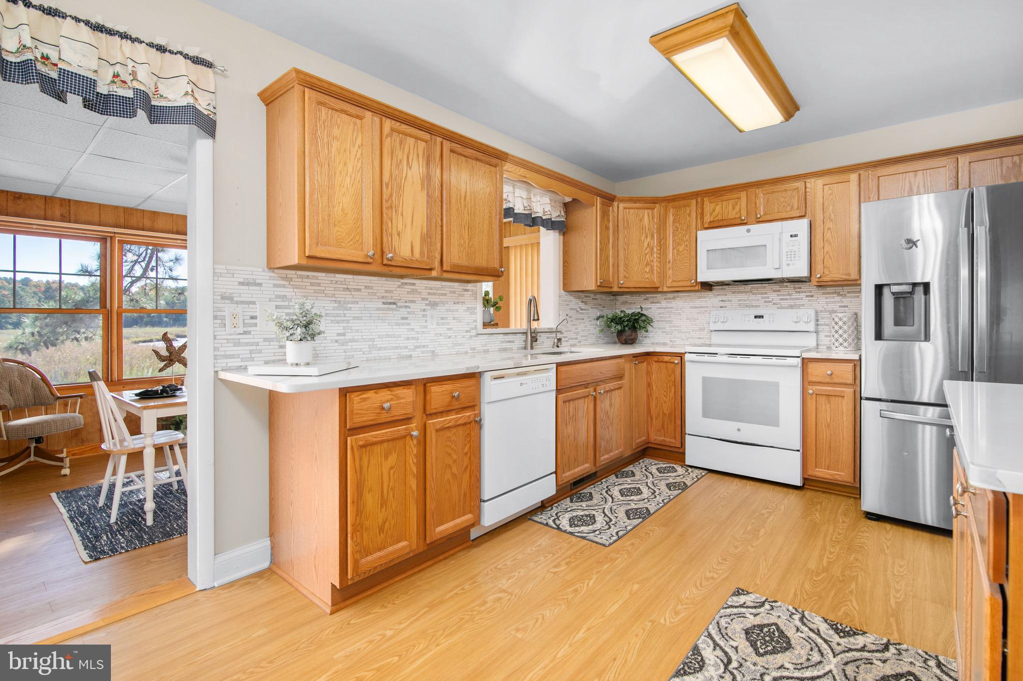 21633 Wetipquin Road Tyaskin, MD 21865 - Photo 17 of 88 a kitchen with stainless steel appliances granite countertop a stove a sink dishwasher and a refrigerator