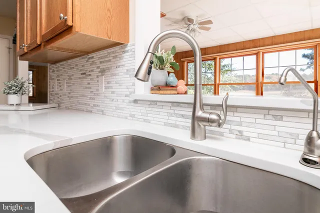 a living room with furniture a couch and a potted plant