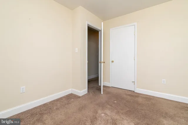 a view of lake with boats and trees in the background
