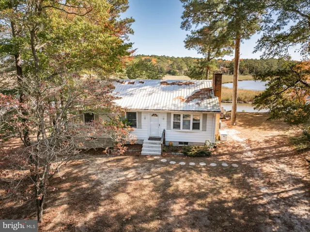 a dining room with furniture a chandelier and wooden floor