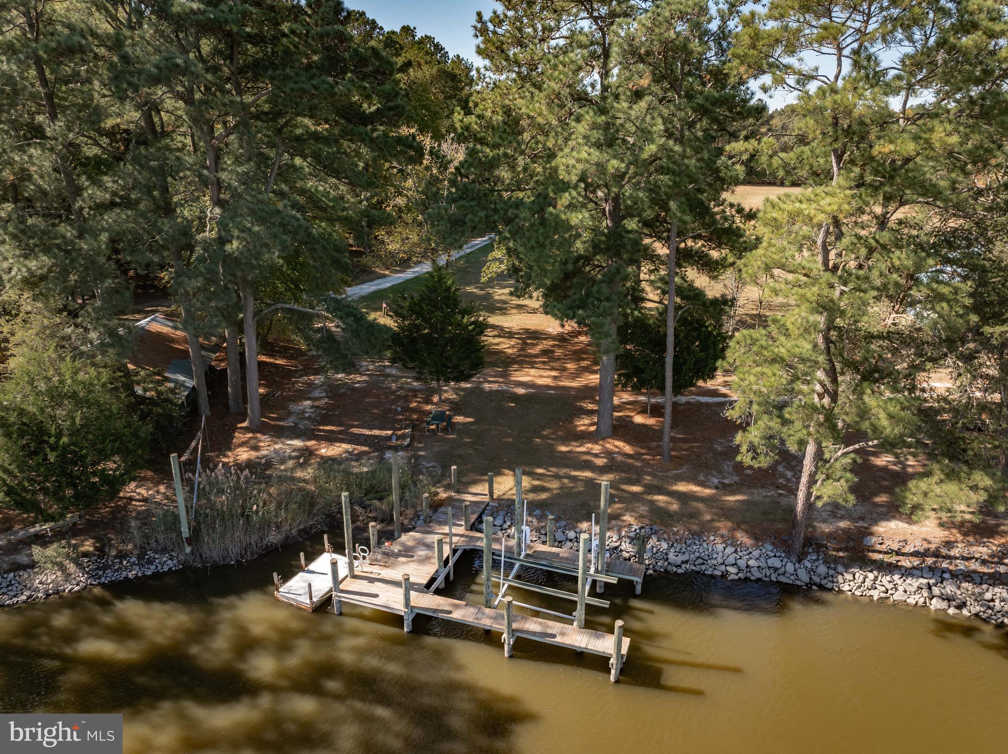 21633 Wetipquin Road Tyaskin, MD 21865 - Photo 46 of 88 a view of a swimming pool with lawn chairs under an umbrella