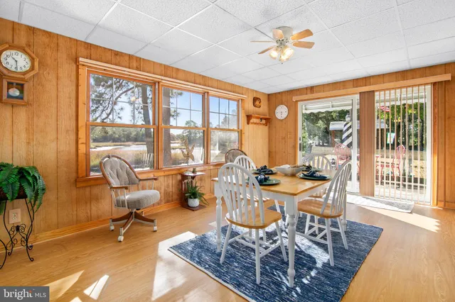 a living room with furniture a flat screen tv and a large window