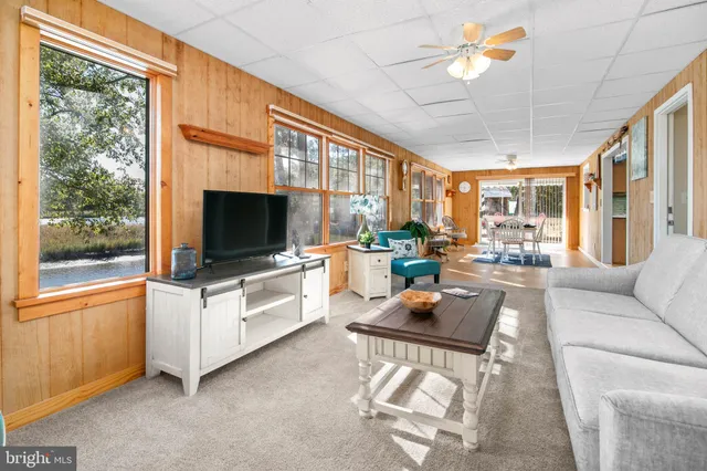 a view of a dining room with furniture wooden floor and a chandelier