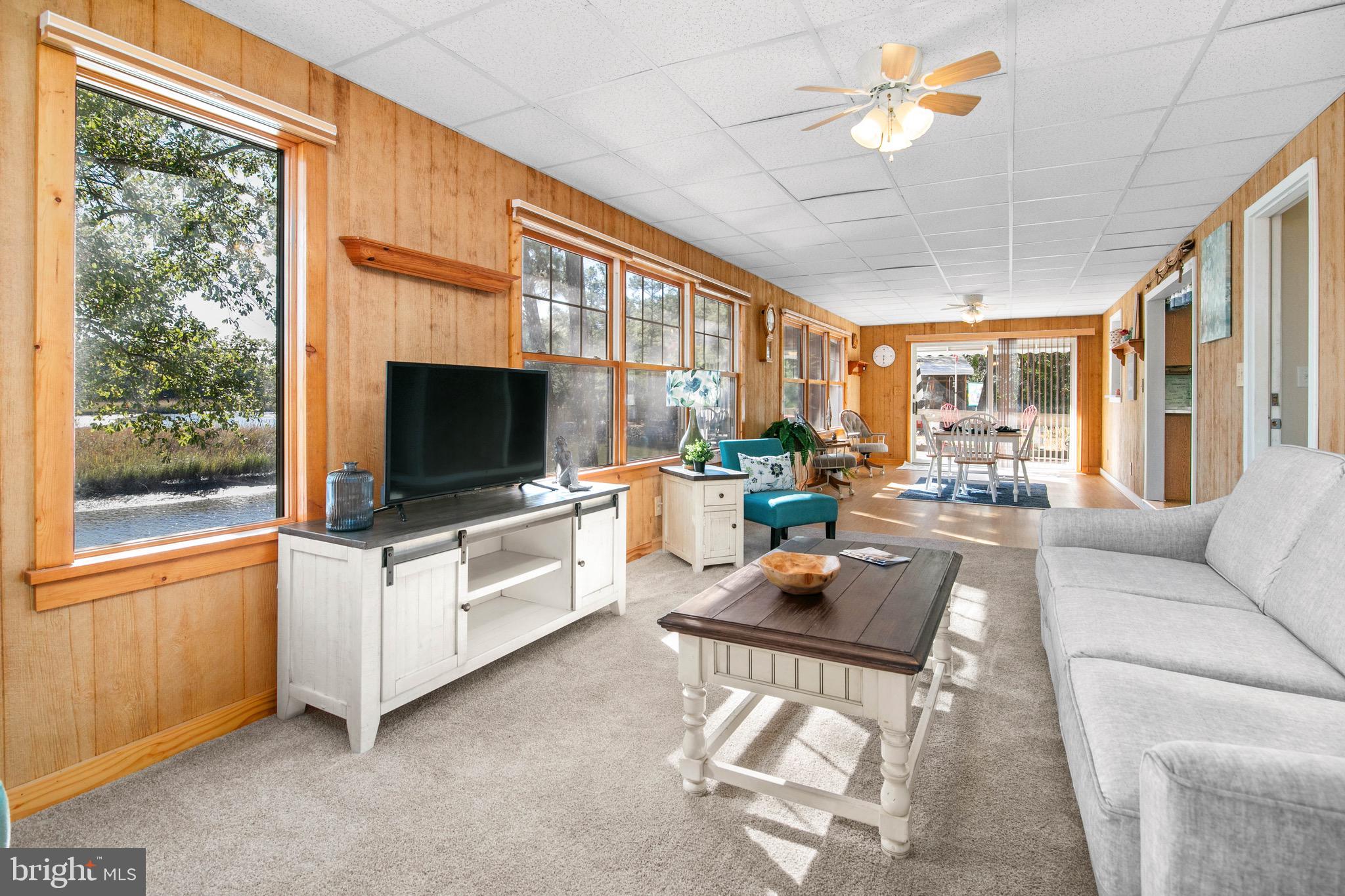21633 Wetipquin Road Tyaskin, MD 21865 - Photo 10 of 88 a living room with furniture a flat screen tv and a large window