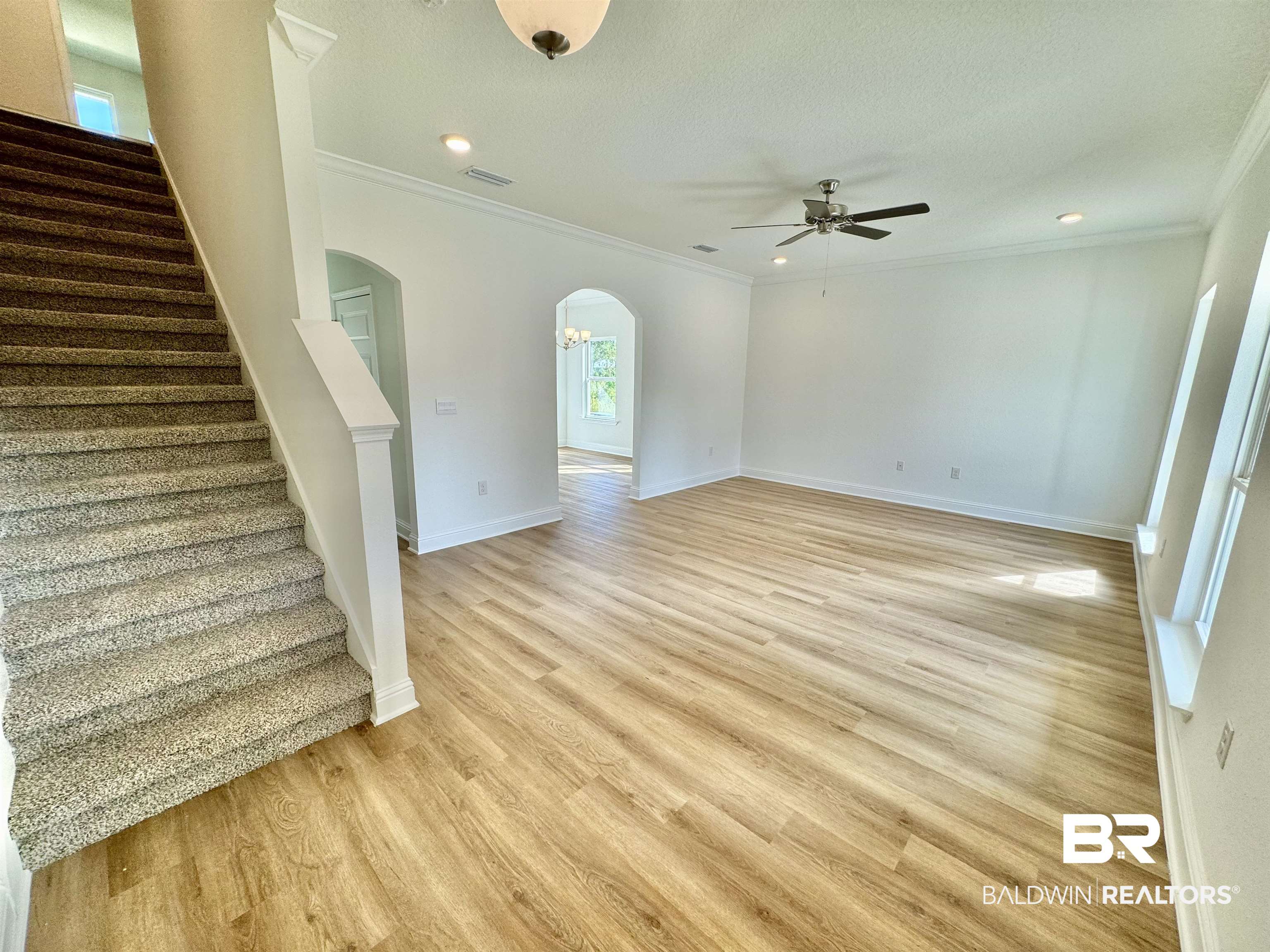 27491 Canal Road Orange Beach, AL 36561 - Photo 7 of 20 Interior space with ornamental molding, light hardwood / wood-style floors, ceiling fan, and a textured ceiling