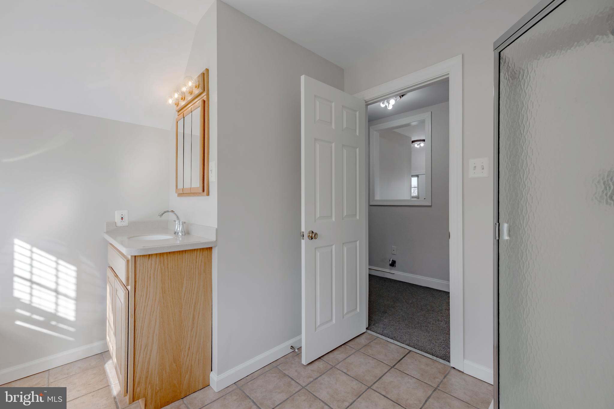 1210 West Darby Road Havertown, PA 19083 - Photo 20 of 33 a view of an empty room with window and bathroom