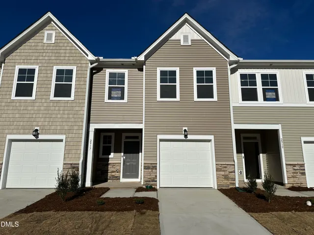 a view of a brick house with large windows
