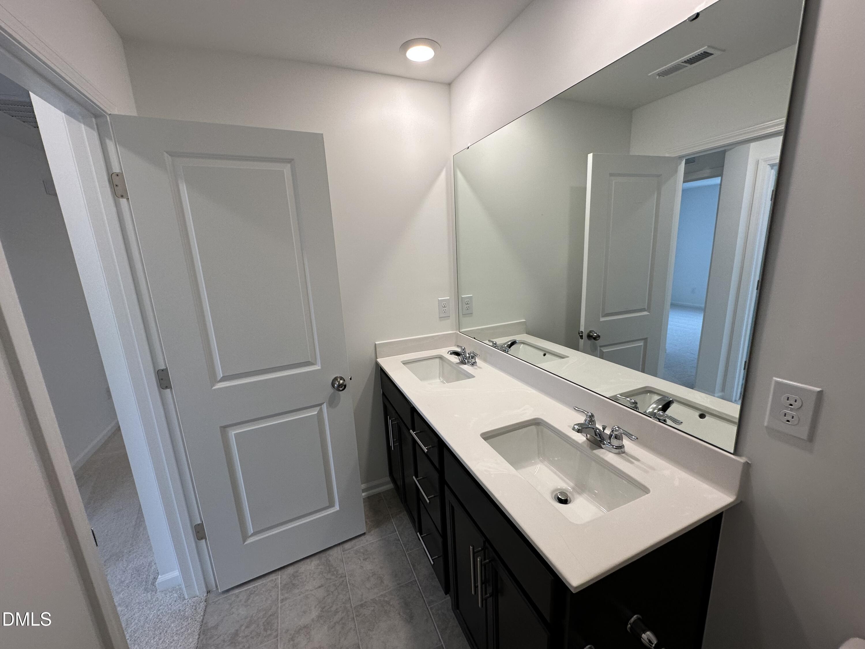 2917 Hickory Fld Drive Raleigh, NC 27616 - Photo 19 of 28 a bathroom with a double vanity sink and mirror