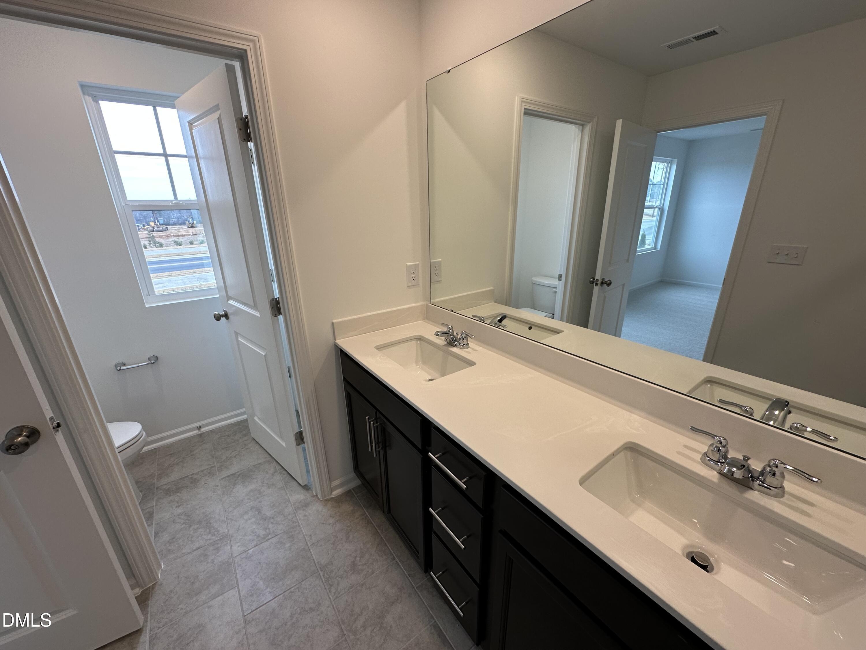 2917 Hickory Fld Drive Raleigh, NC 27616 - Photo 26 of 28 a bathroom with a double vanity sink a and mirror