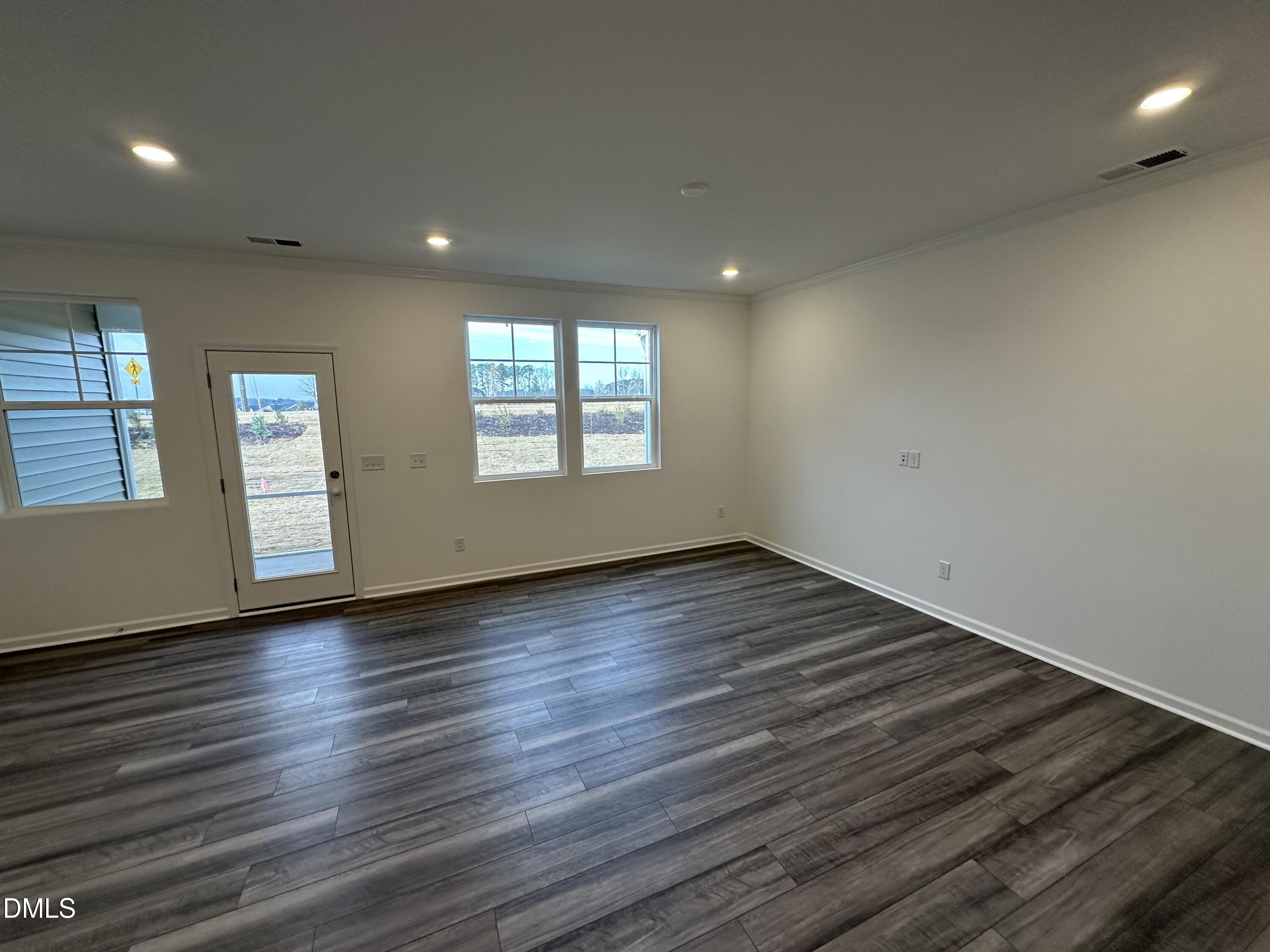 2917 Hickory Fld Drive Raleigh, NC 27616 - Photo 4 of 28 an empty room with wooden floor and windows