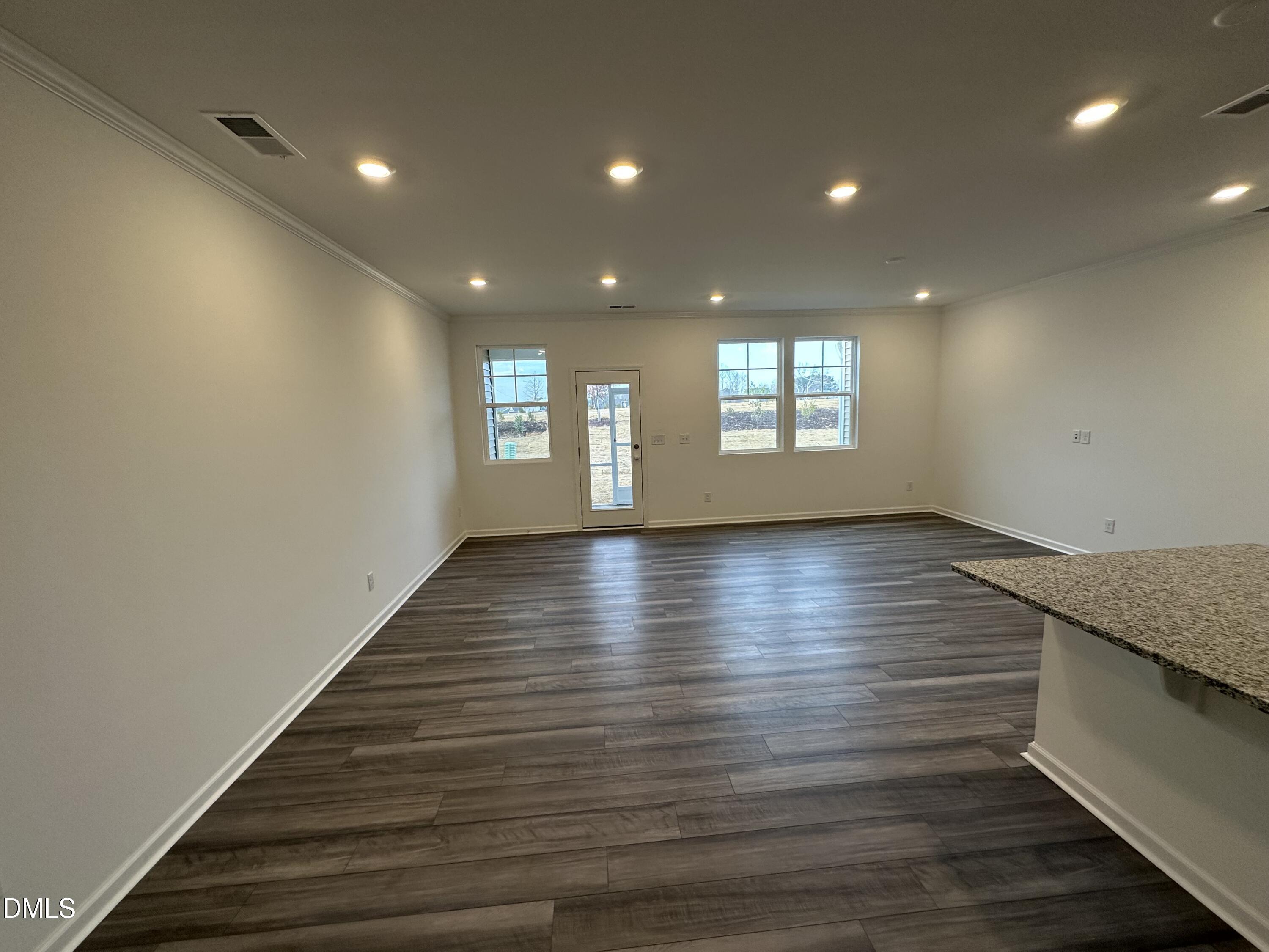 2917 Hickory Fld Drive Raleigh, NC 27616 - Photo 8 of 28 an empty room with wooden floor and windows