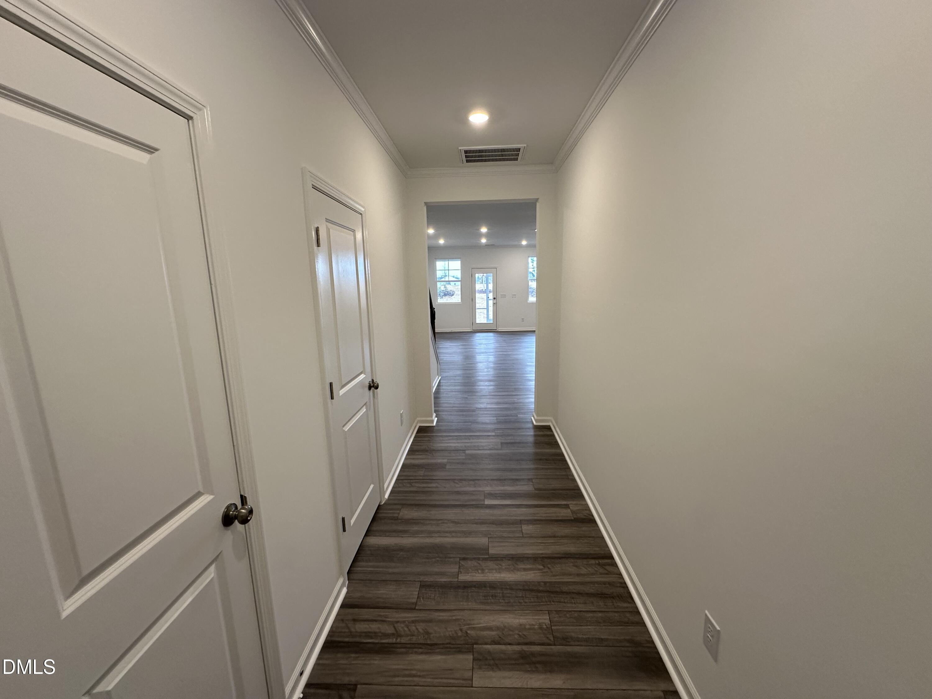 2917 Hickory Fld Drive Raleigh, NC 27616 - Photo 9 of 28 a view of a hallway with wooden floor and staircase