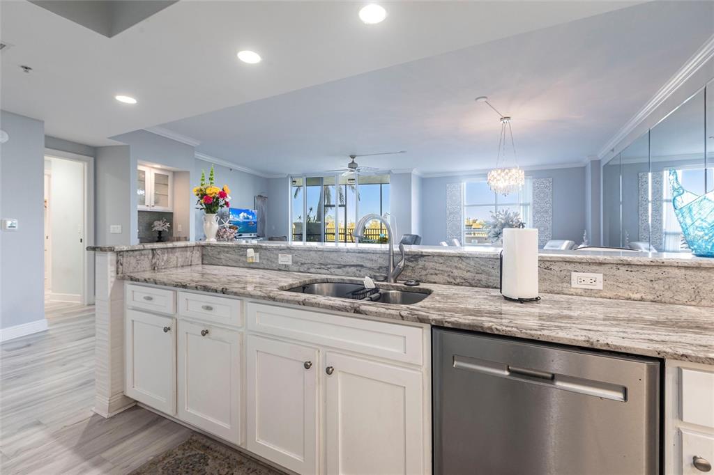 3329 Sunset Key Circle, Unit 107 Punta Gorda, FL 33955 - Photo 14 of 76 a kitchen with granite countertop a sink and white cabinets