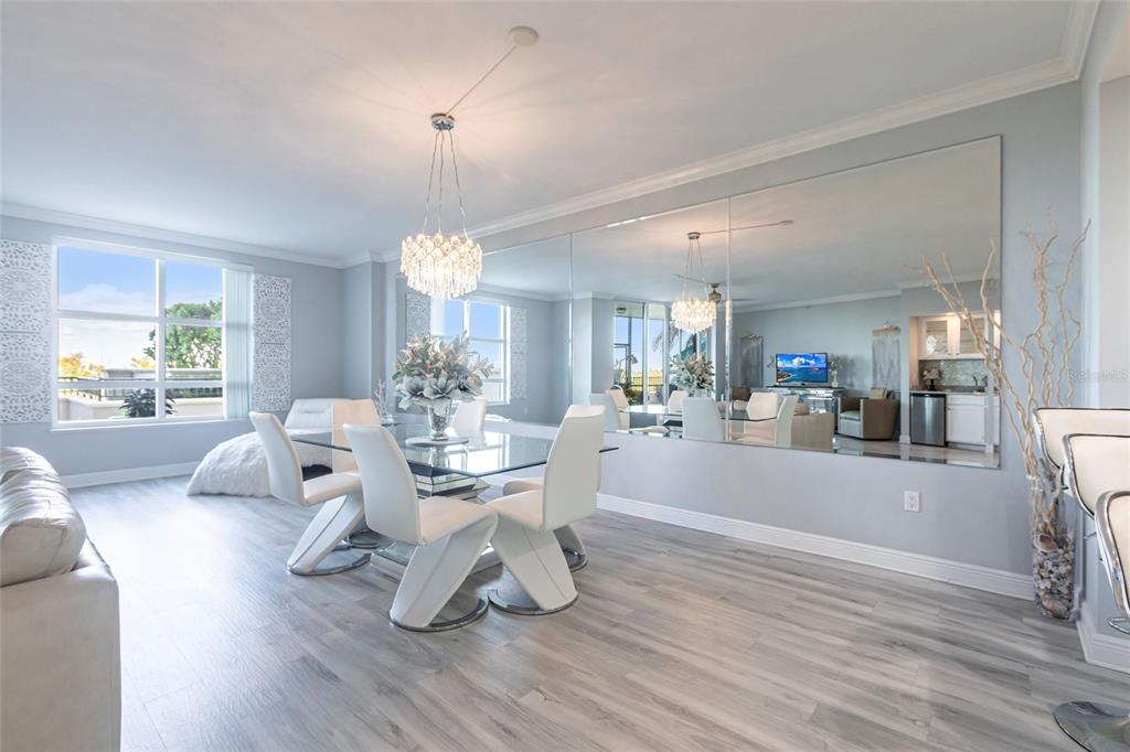 3329 Sunset Key Circle, Unit 107 Punta Gorda, FL 33955 - Photo 16 of 76 a living room with furniture a dining table and a large window