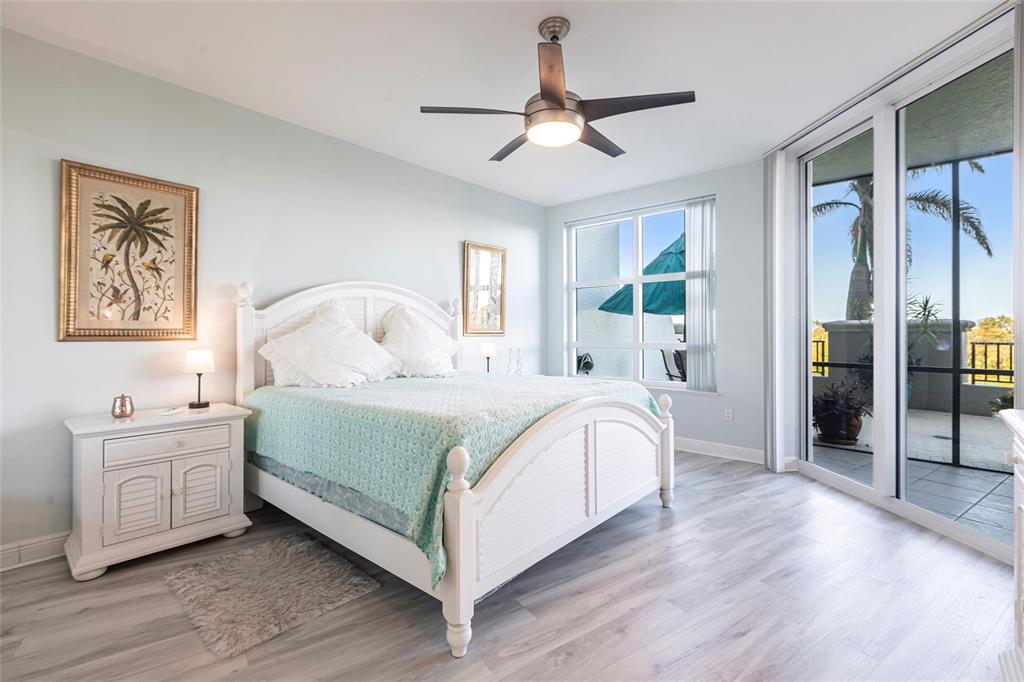 3329 Sunset Key Circle, Unit 107 Punta Gorda, FL 33955 - Photo 19 of 76 a bedroom with a large bed and a chandelier