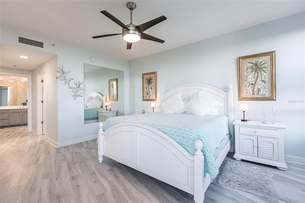 3329 Sunset Key Circle, Unit 107 Punta Gorda, FL 33955 - Photo 20 of 76 a bedroom with a large bed and a chandelier