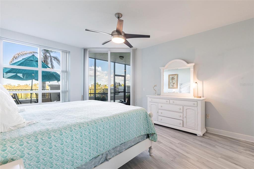 3329 Sunset Key Circle, Unit 107 Punta Gorda, FL 33955 - Photo 21 of 76 a bedroom with a large bed and a window