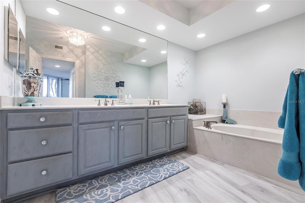 3329 Sunset Key Circle, Unit 107 Punta Gorda, FL 33955 - Photo 22 of 76 a spacious bathroom with a double vanity sink a mirror and a bathtub