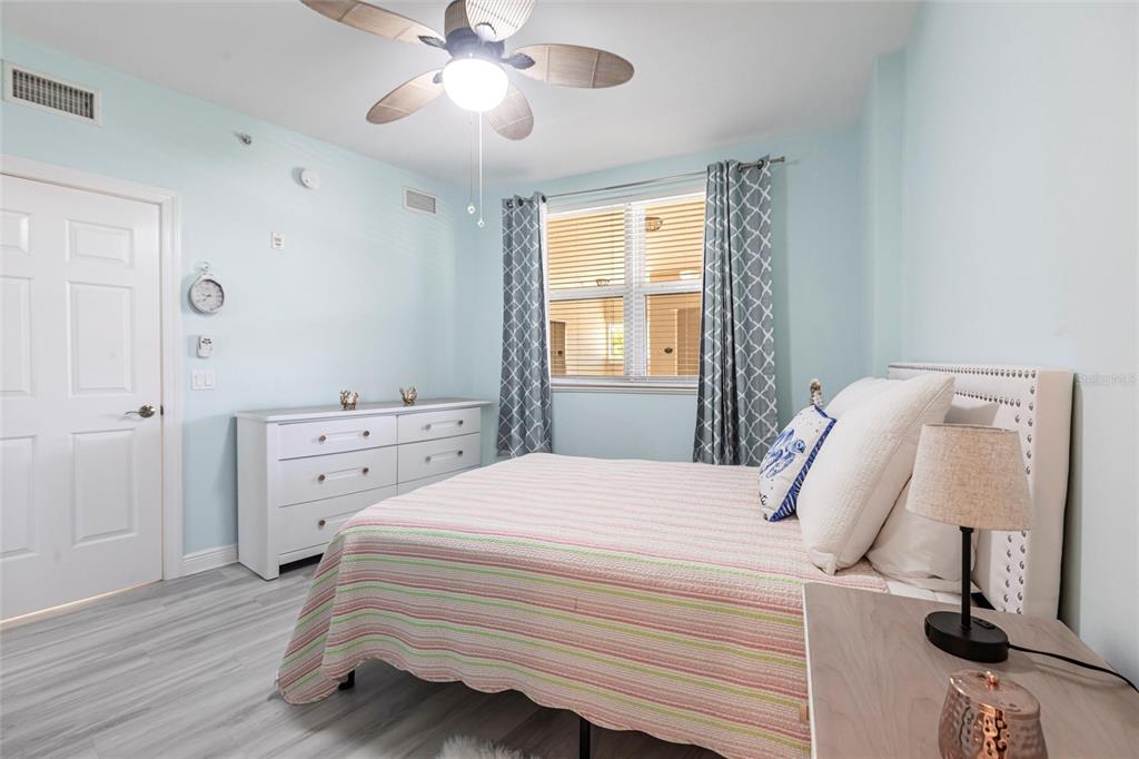 3329 Sunset Key Circle, Unit 107 Punta Gorda, FL 33955 - Photo 24 of 76 a bedroom with a bed and wooden floor