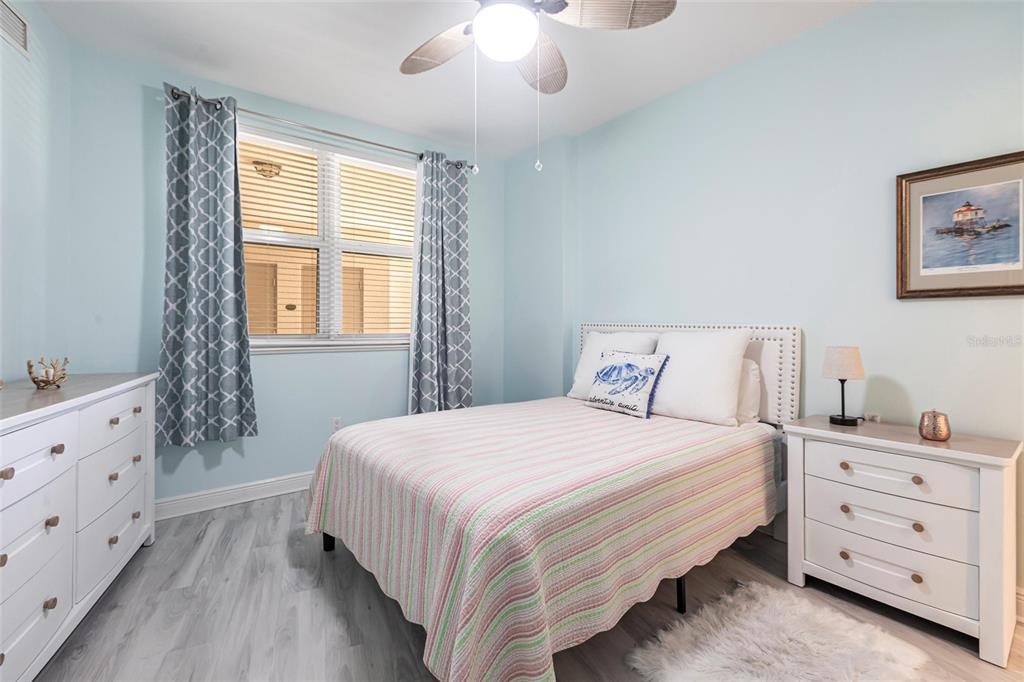 3329 Sunset Key Circle, Unit 107 Punta Gorda, FL 33955 - Photo 25 of 76 a bedroom with a bed and a dresser