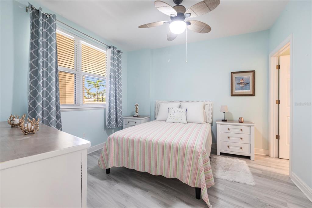 3329 Sunset Key Circle, Unit 107 Punta Gorda, FL 33955 - Photo 26 of 76 a bedroom with a bed and a chandelier