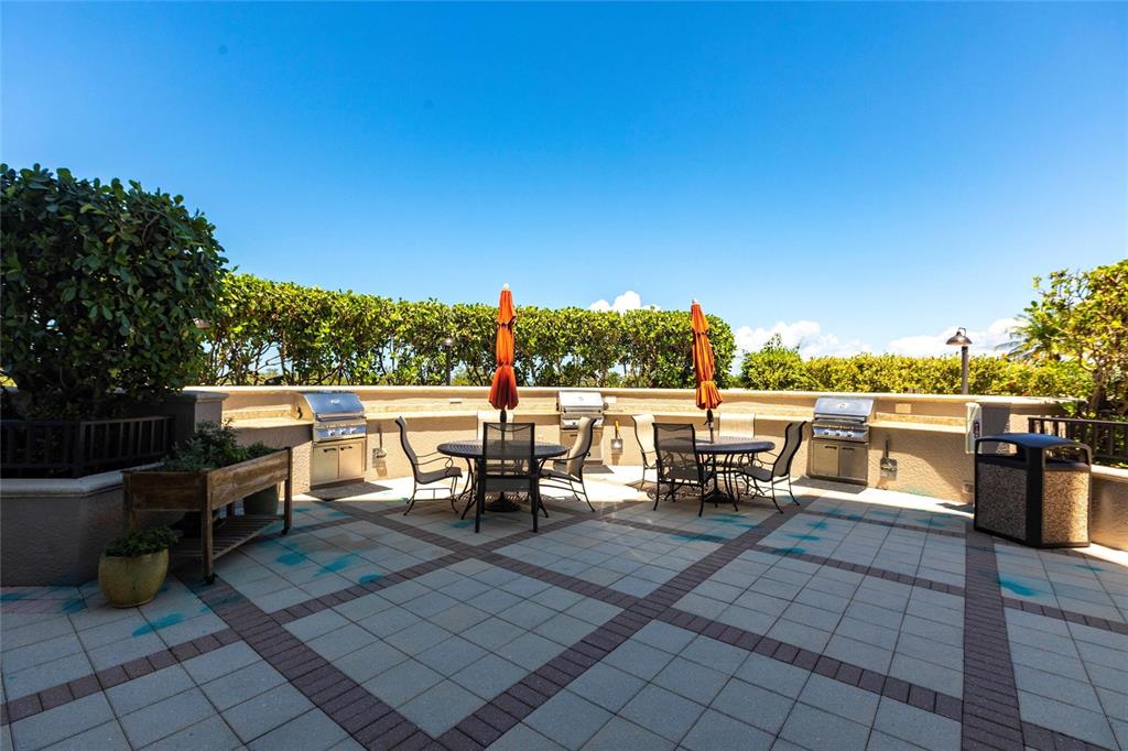 3329 Sunset Key Circle, Unit 107 Punta Gorda, FL 33955 - Photo 40 of 76 a view of a patio with dining table and chairs with wooden fence