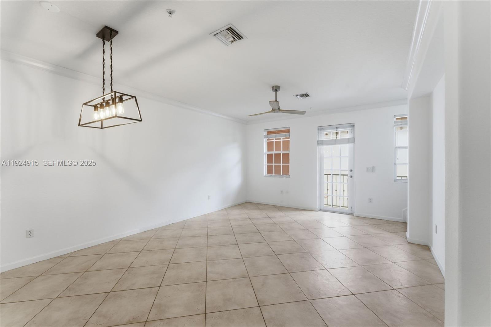 2651 Southwest 119th Terrace, Unit 1109 Miramar, FL 33025 - Photo 11 of 25 a view of a room with window and chandelier