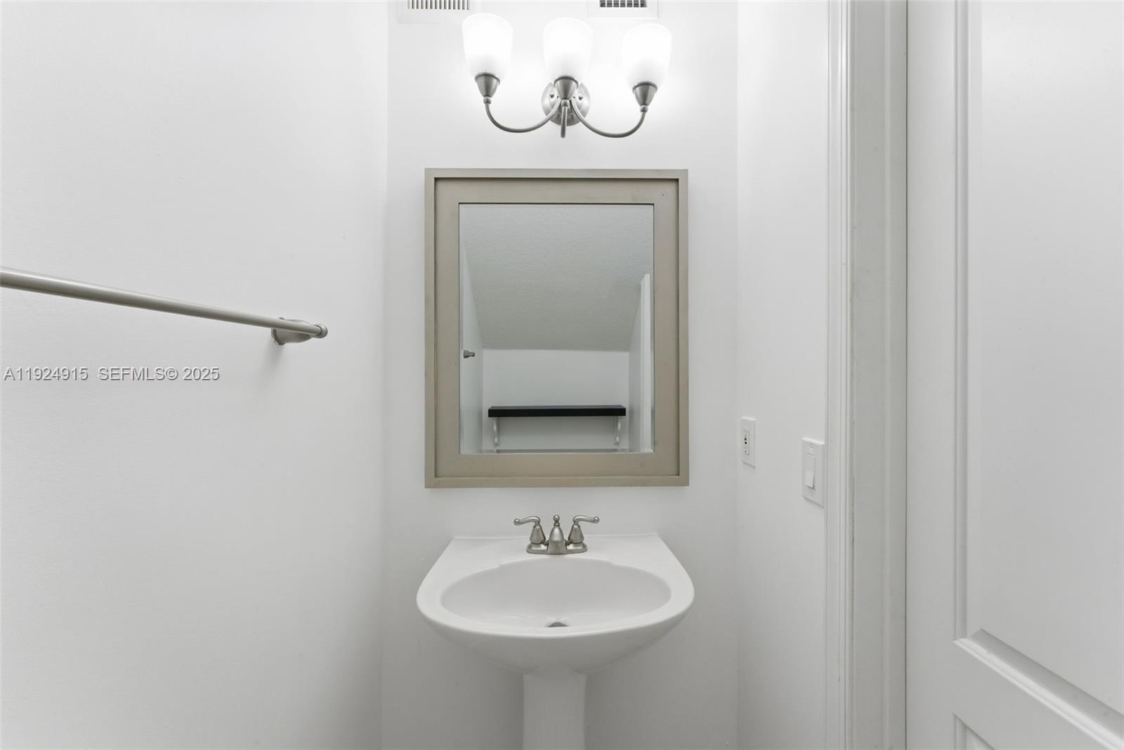 2651 Southwest 119th Terrace, Unit 1109 Miramar, FL 33025 - Photo 16 of 25 a bathroom with a sink and a mirror