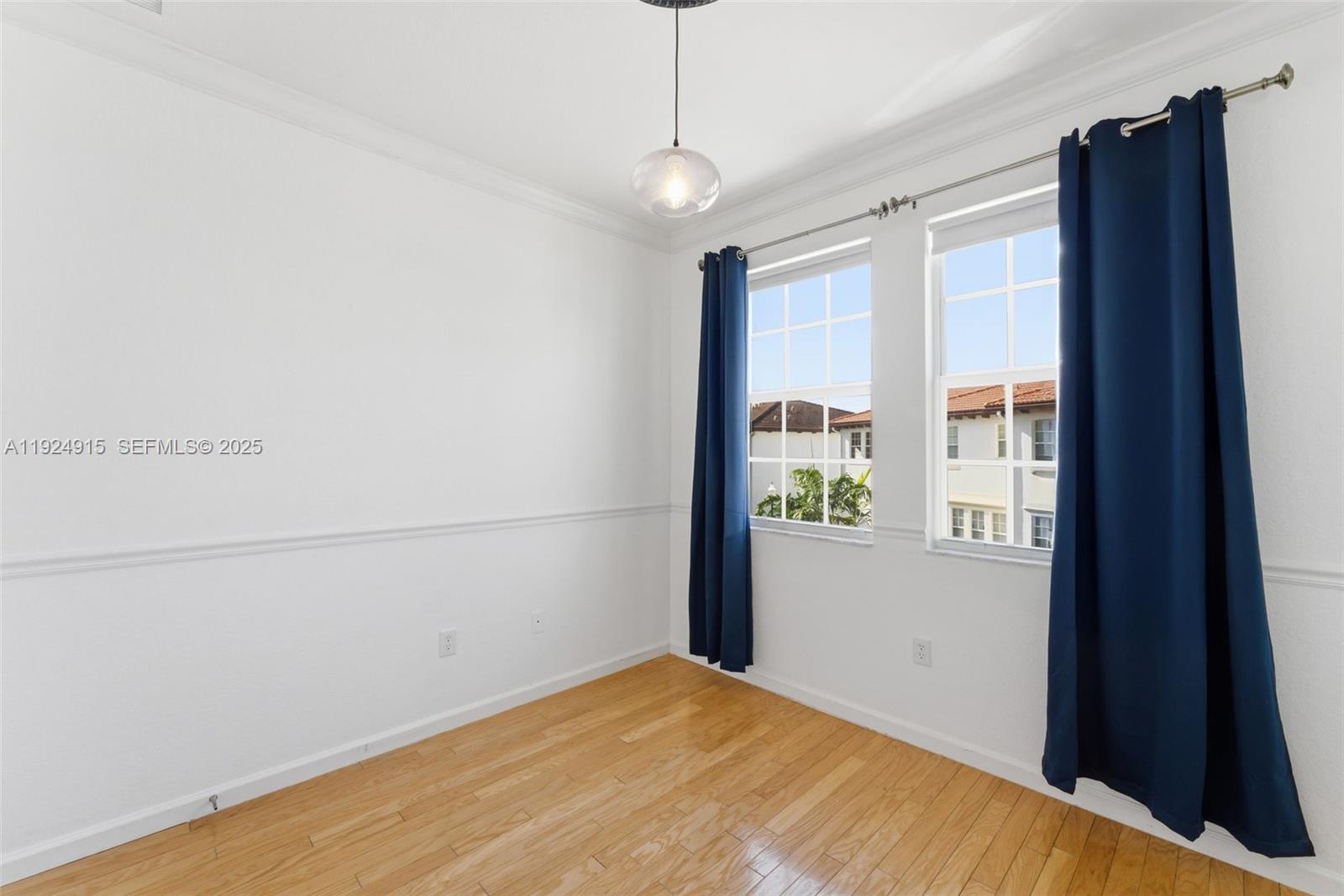 2651 Southwest 119th Terrace, Unit 1109 Miramar, FL 33025 - Photo 20 of 25 a view of a livingroom with wooden floor and a window