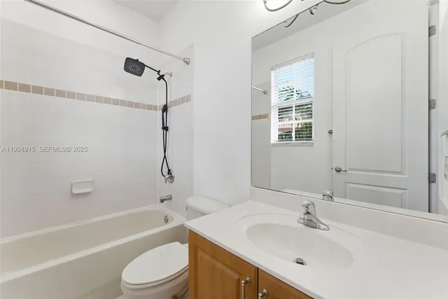 a bathroom with a sink toilet tub and shower