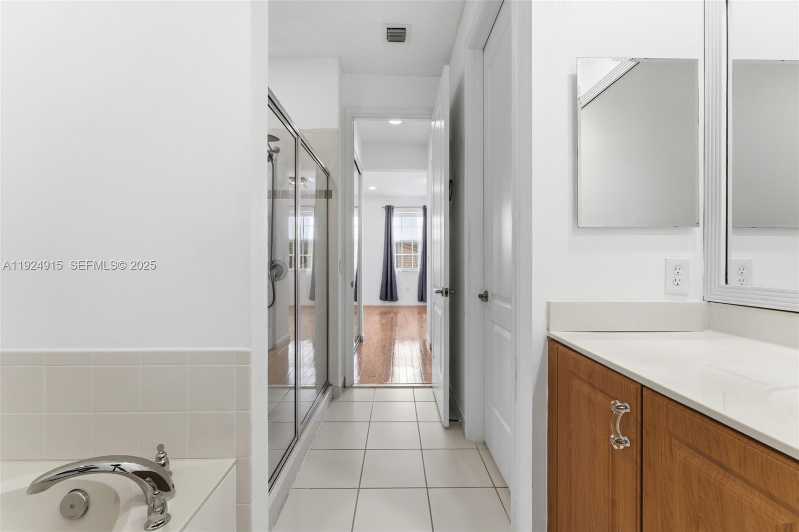2651 Southwest 119th Terrace, Unit 1109 Miramar, FL 33025 - Photo 22 of 25 a bathroom with a sink and a mirror