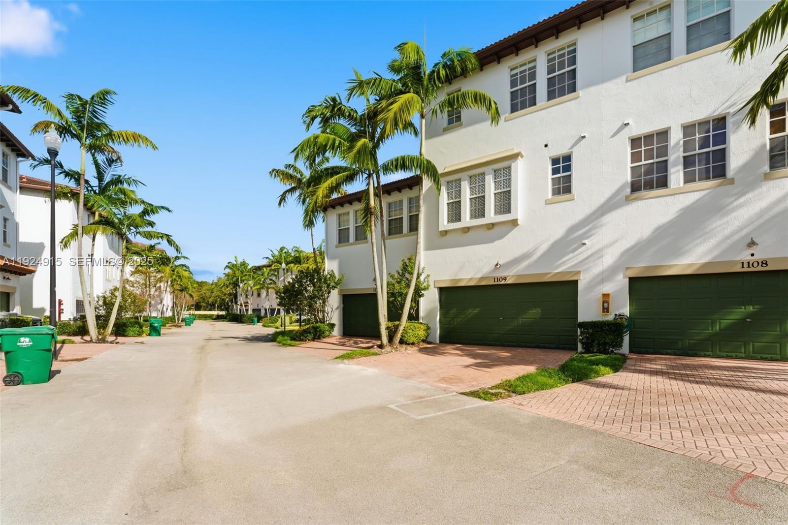 2651 Southwest 119th Terrace, Unit 1109 Miramar, FL 33025 - Photo 5 of 25 a front view of a house with a yard and a garage