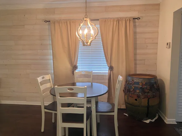 a dining room with furniture and wooden floor