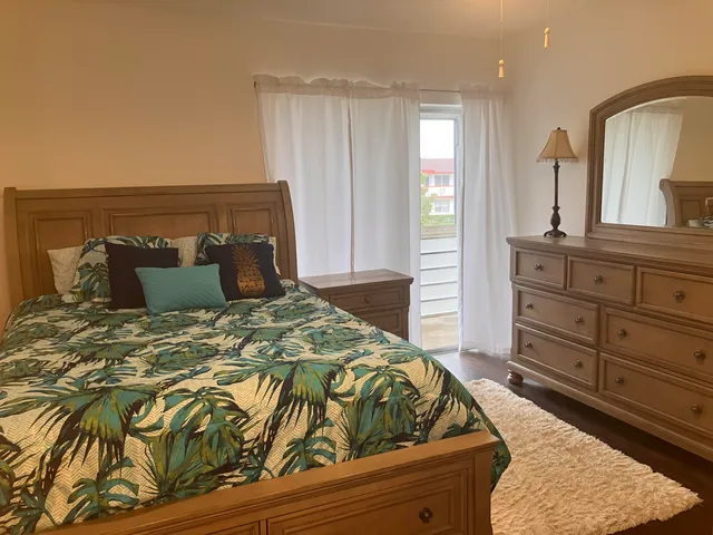 a bedroom with a bed and a dresser
