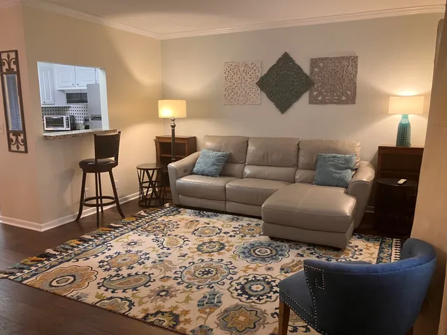 a living room with furniture and a lamp
