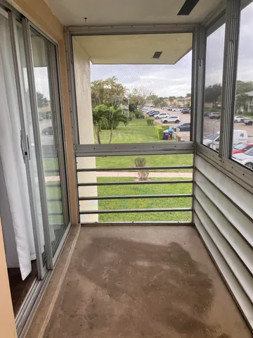 a view of a room that has a large window and front view