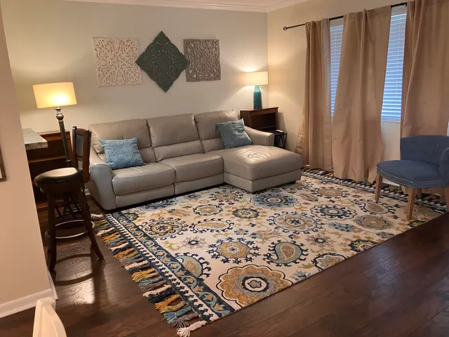 a living room with furniture and a lamp