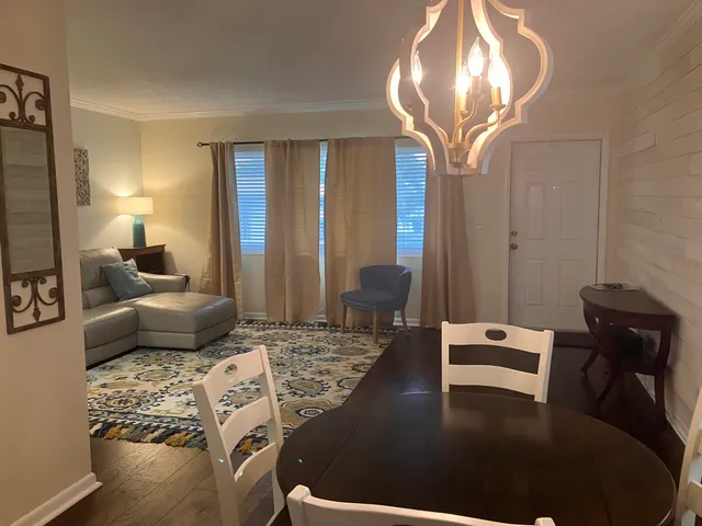 a bedroom with furniture and a mirror