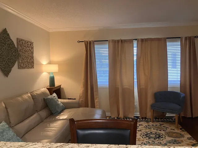 a living room with furniture and a lamp