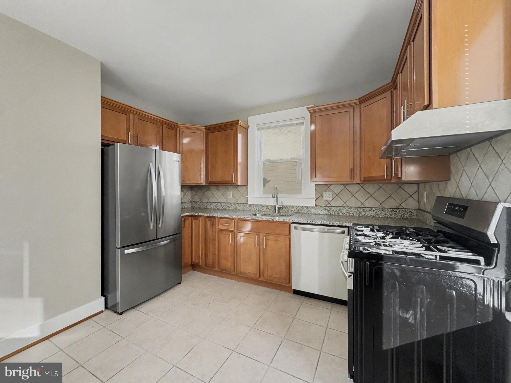 5505 Tramore Road Baltimore, MD 21214 - Photo 2 of 28 a kitchen with stainless steel appliances granite countertop a refrigerator stove and sink