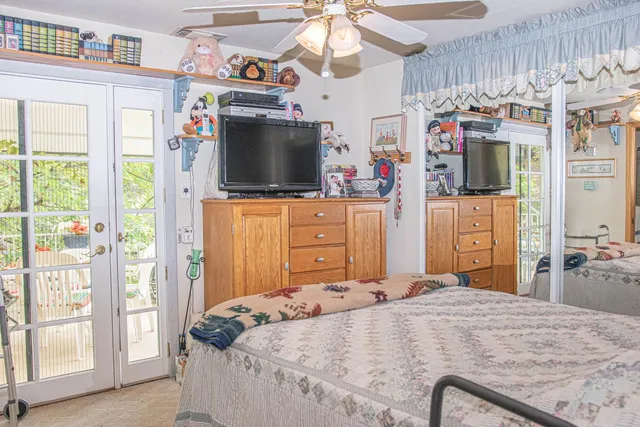 a bedroom with a bed and flat screen tv