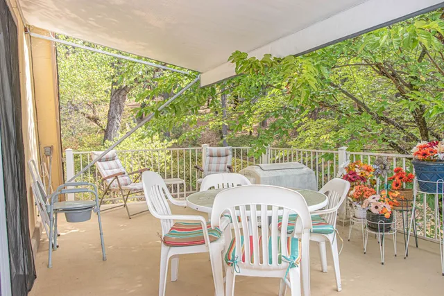a view of a chairs and table in patio