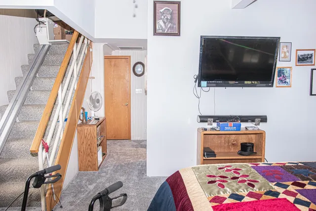 a living room with a flat screen tv and a rug