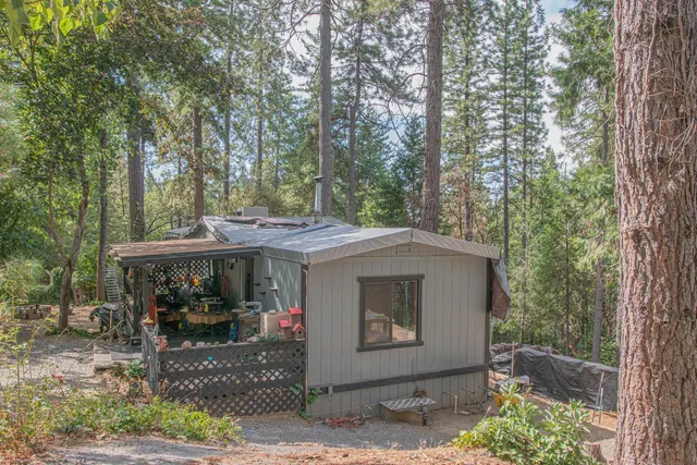 a kitchen with stainless steel appliances a stove a chimney a dining table and chairs