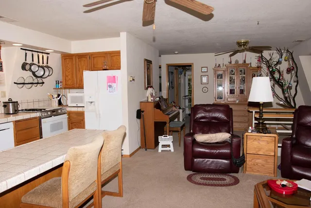 a kitchen with a refrigerator and a stove top oven