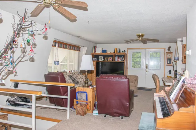 a bedroom with furniture and a flat screen tv